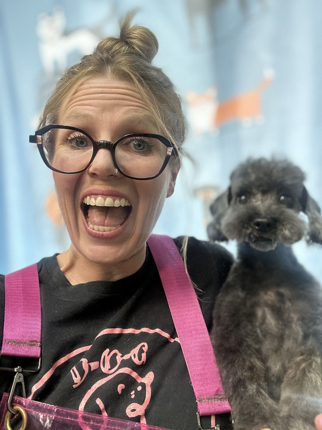 Heather with a freshly groomed grey poodle